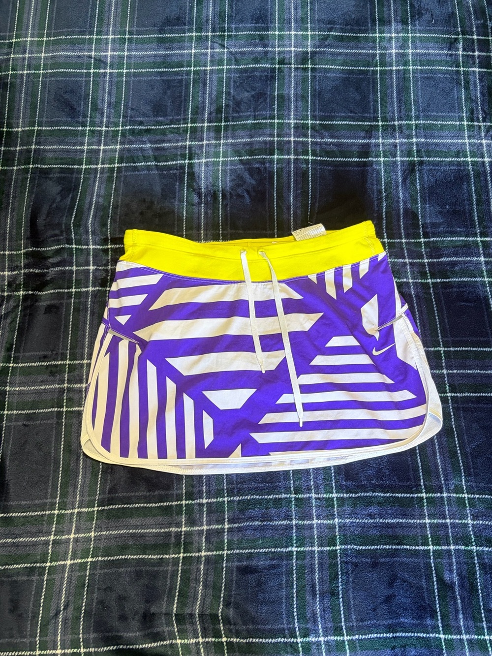 Nike tennis skirt w/purple/white stripes & yellow top band. Size XS.